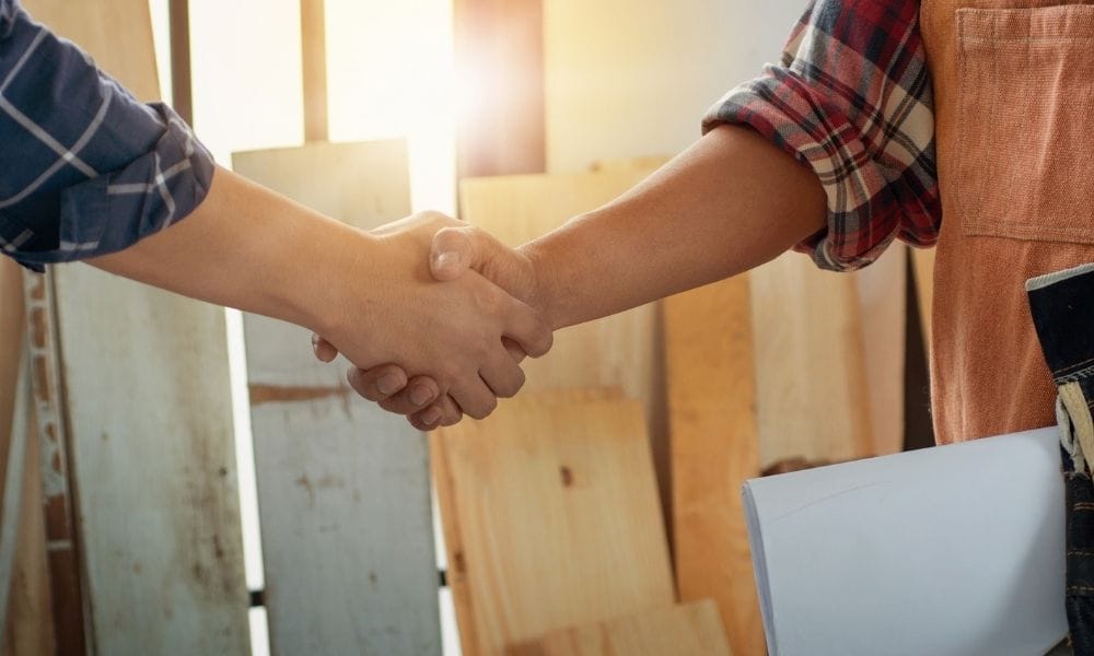 A business deal signified by two people shaking hands