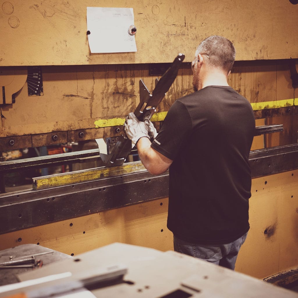 Man working on part in manufacturing plant
